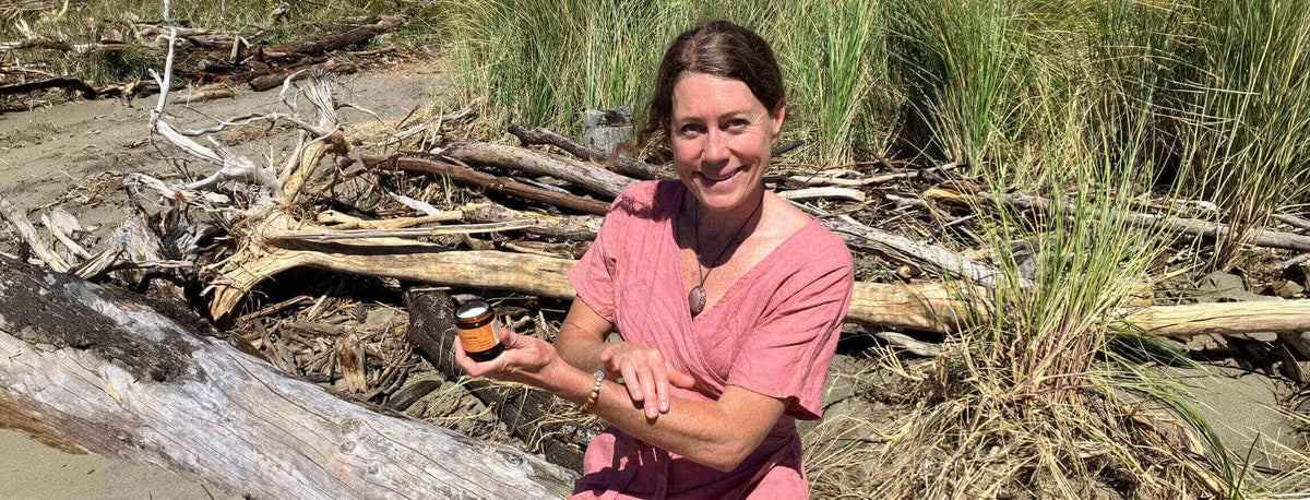 Woman sitting in nature holding a product 