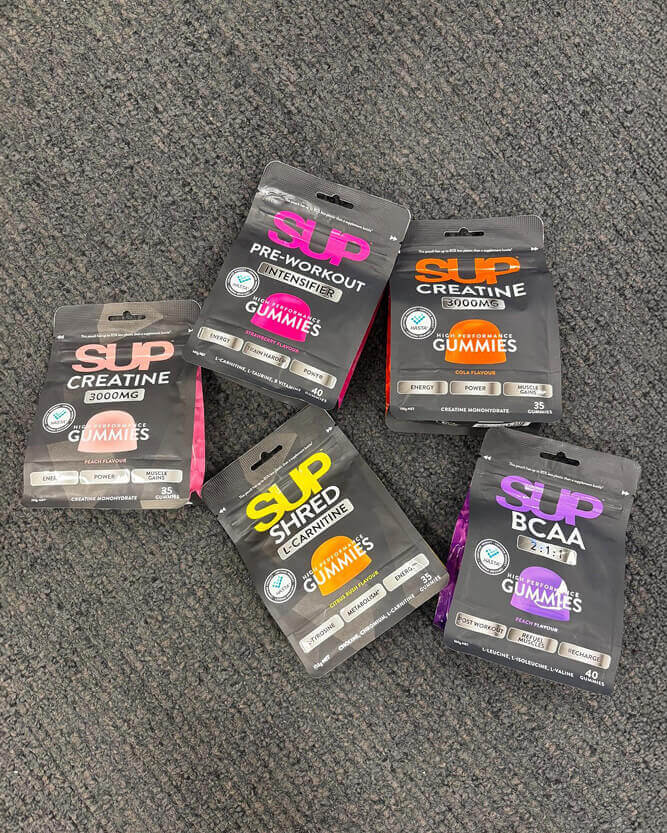 Assorted health supplement packages on a gray surface.