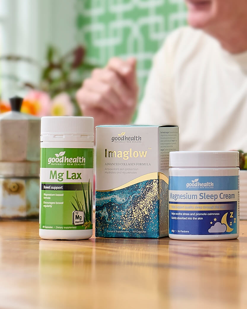 Three health products from Goodhealth on a table with a blurred background.