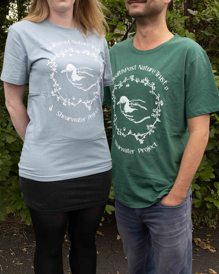 Two people wearing t-shirts with nature-themed designs and text.