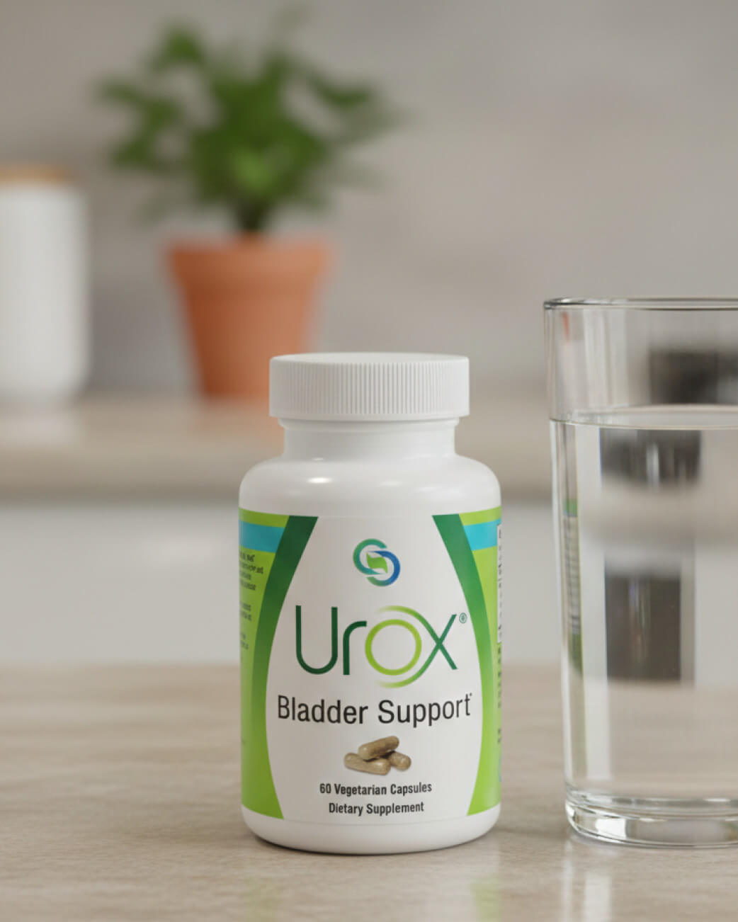 Bottle of Urox Bladder Support on a table with a glass of water and plant in the background