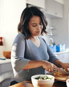 Woman preparing food in a kitchen.