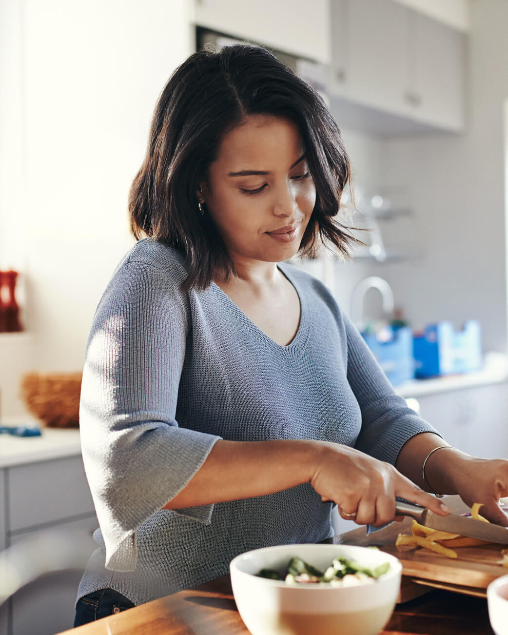Woman preparing food in a kitchen.