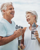 Two people holding water bottles against a light background.