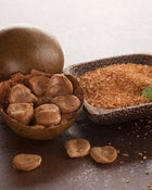 Wooden bowl with monk fruit and brown sugar on a textured surface