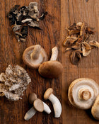 Assorted mushrooms on a wooden surface