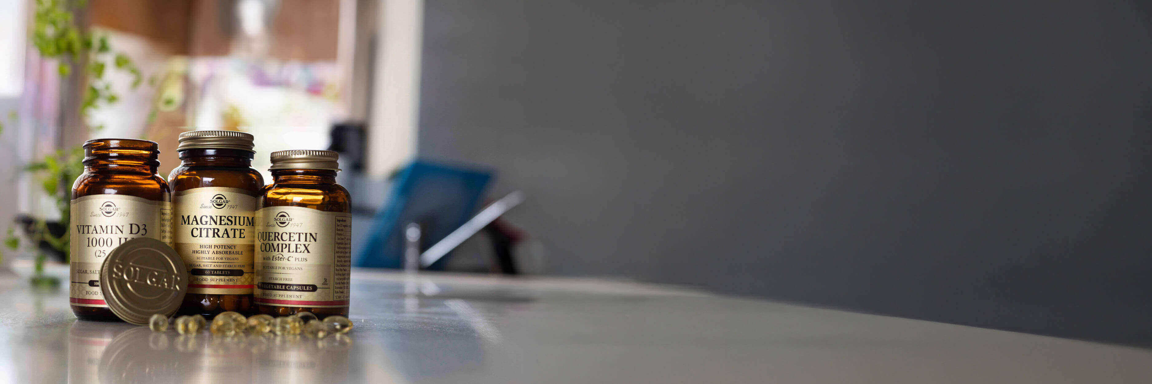Supplement bottles on a table with a blurred background.