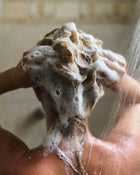 Woman washing her hair in the shower.