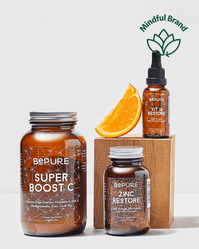 Three brown bottles labeled 'Super Boost C', 'Vit D Restore', and 'Zinc Restore' with an orange wedge on a white background, featuring the Mindful Brand logo.