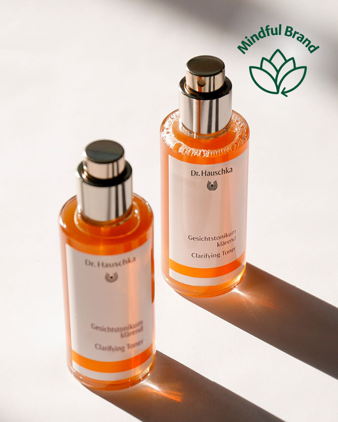 Two bottles of Dr. Hauschka skincare product with a 'Mindful Brand' logo in the corner.