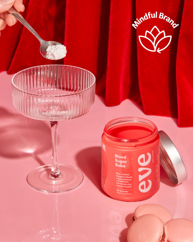 Pink supplement jar labeled 'eve' with a glass and spoon on a pink background, featuring the 'Mindful Brand' logo.