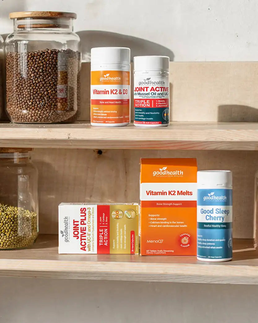 Supplement products on a wooden shelf with jars in the background.