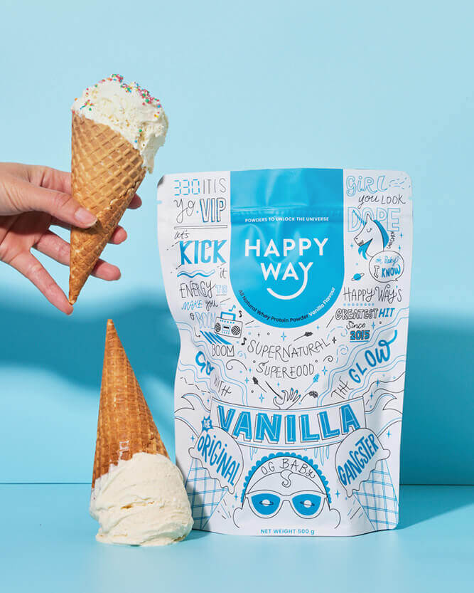 Hand holding a vanilla ice cream cone next to a 'Happy Way' vanilla ice cream package on a blue background.