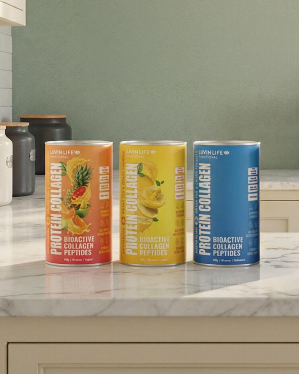 Three cans of Protein Collagen on a kitchen counter with a neutral background.
