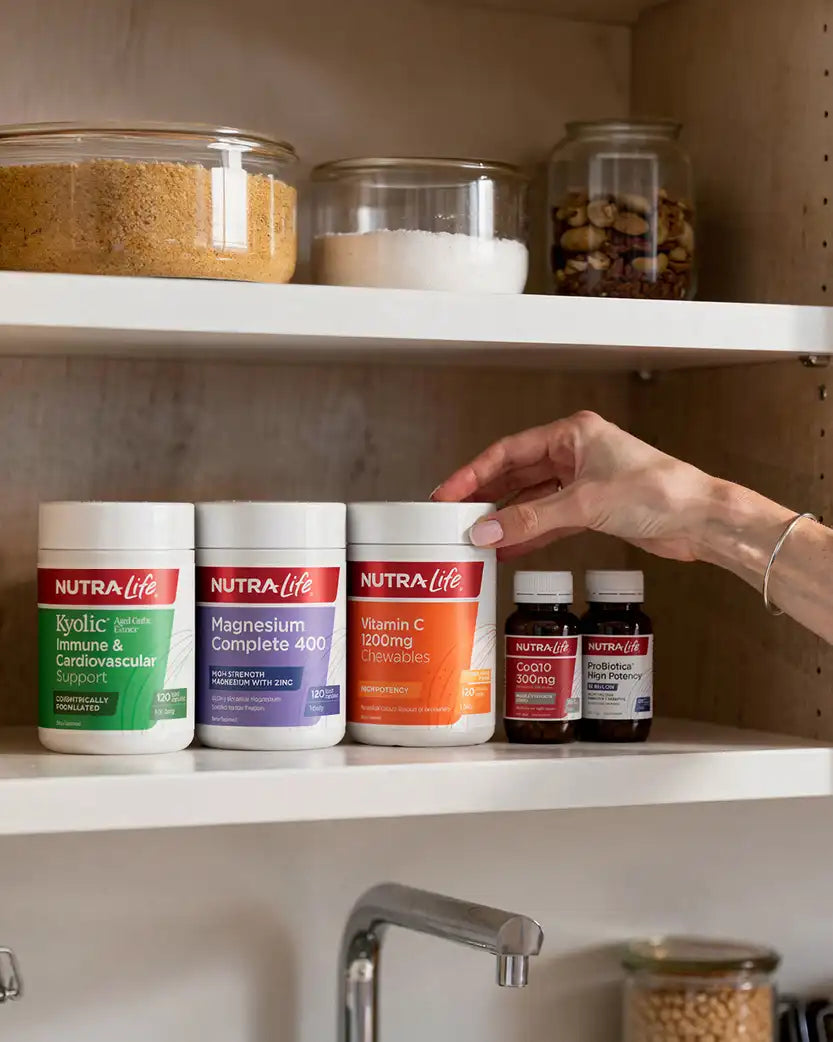 NutraLife supplement containers on a kitchen shelf.