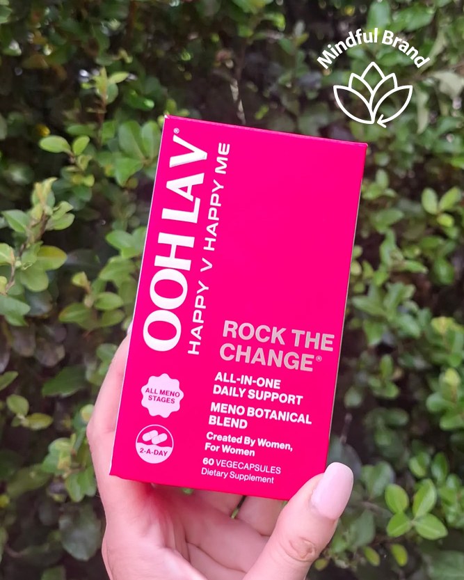 Ooh La V Rock the Change supplement in vibrant pink box packaging with a person holding it in front of a bush. White mindful brand logo in the corner.