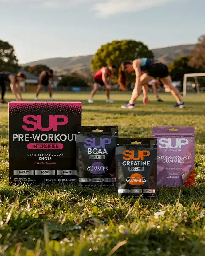 Supplement packages on grass with people exercising in the background.