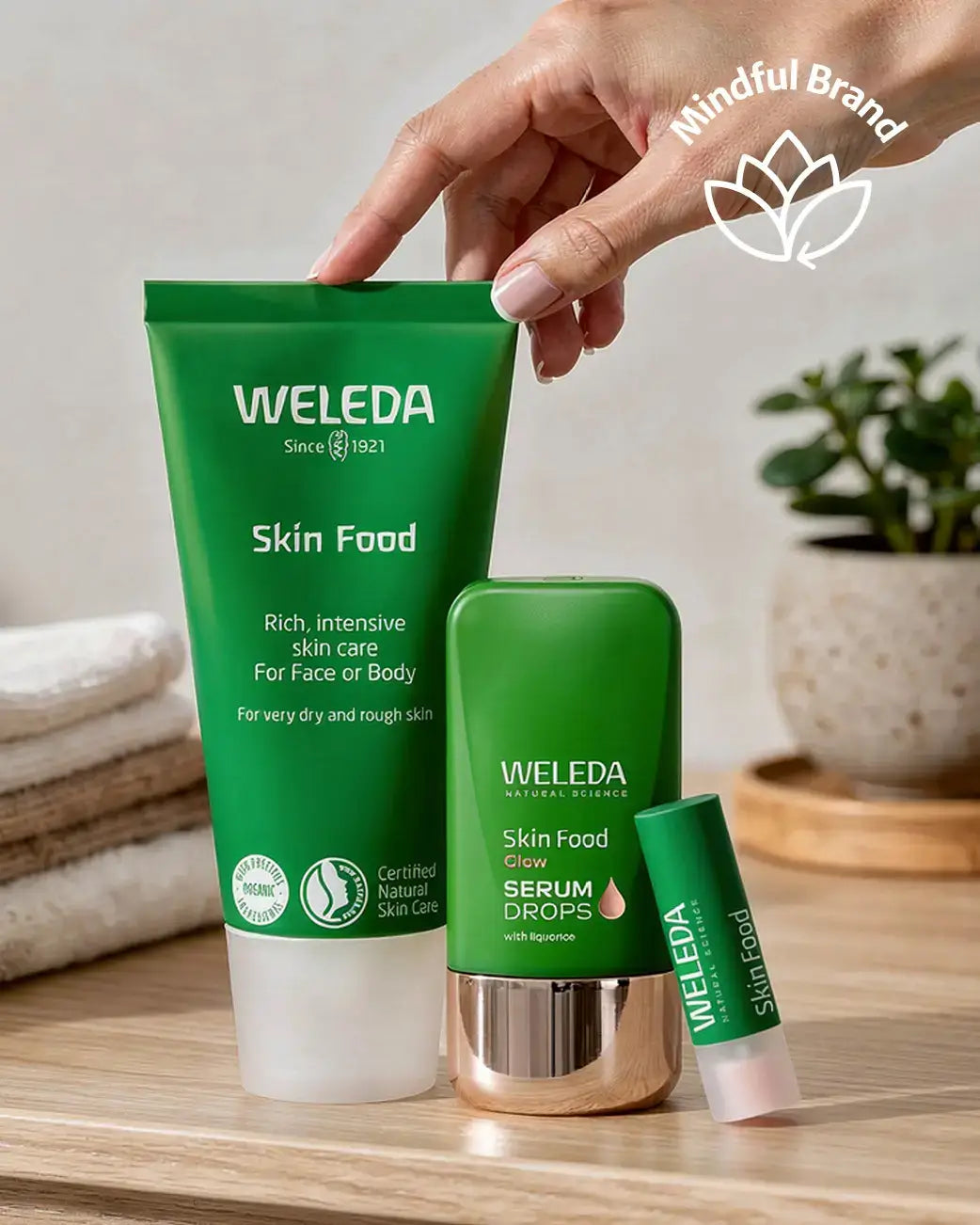 Weleda Skin Food products on a wooden surface with a blurred background