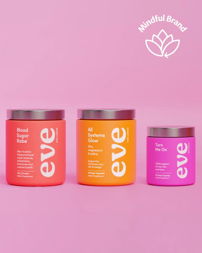 Three supplement containers from the brand eve, displayed against a solid pink background. The containers are coral pink, orange, and magenta, with silver lids, and feature white text.