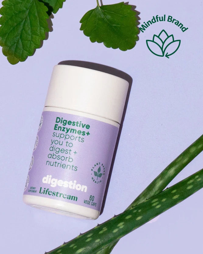 A flat-lay product arrangement featuring a central green bottle labeled 'Biogenic Aloe Vera Tonic' surrounded by several white supplement jars, a pineapple slice, aloe vera leaves, and a small dish of capsules on a pale blue background. A 'Mindful Brand' logo appears in the upper right.