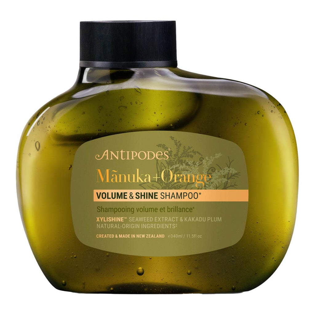Antipodes Manuka + Orange Volume & Shine Shampoo bottle on a white background.