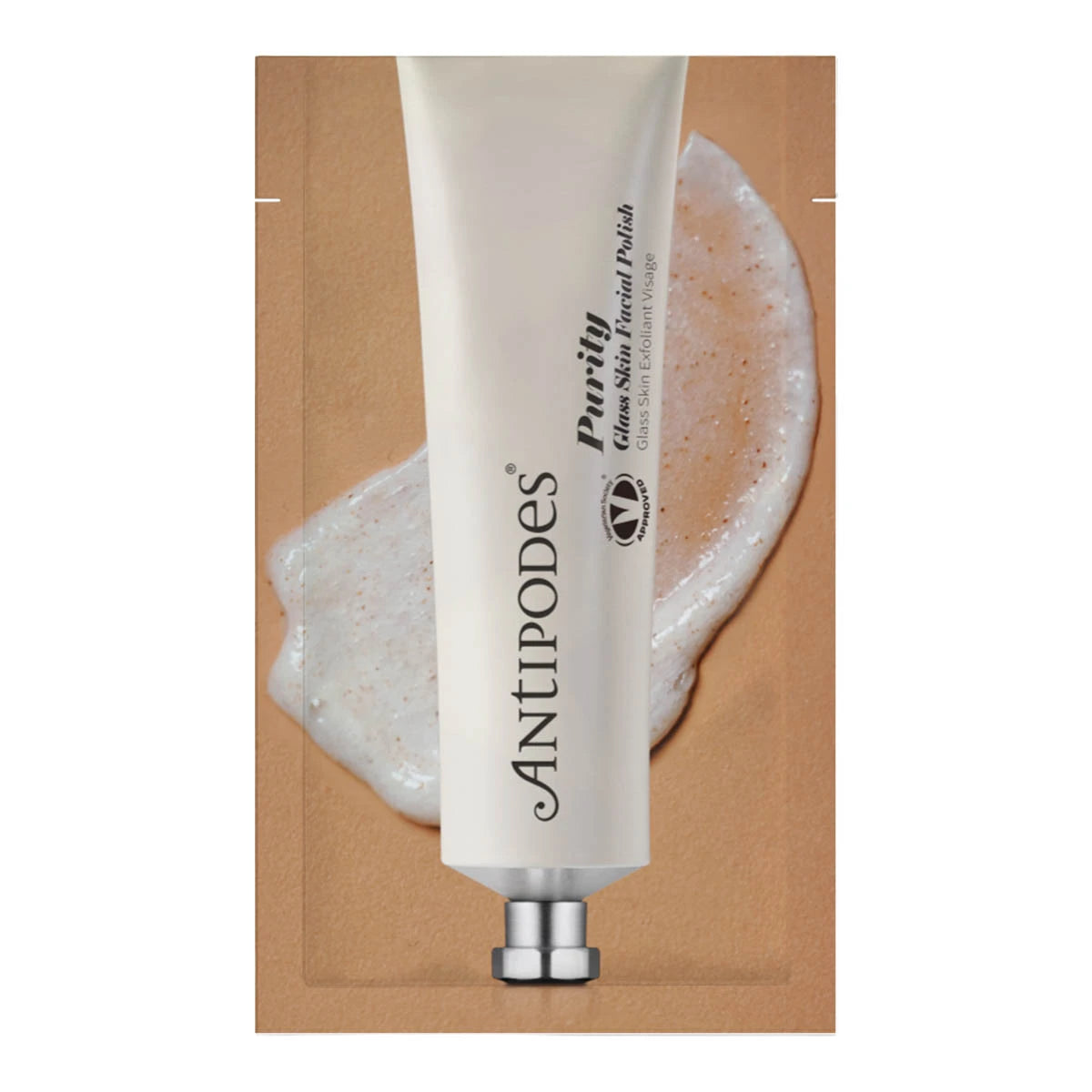 A single tube of Antipodes Purify Gentle Facial Polish centered on a kraft-paper-style square background, with a smear of pale cream product behind it.
