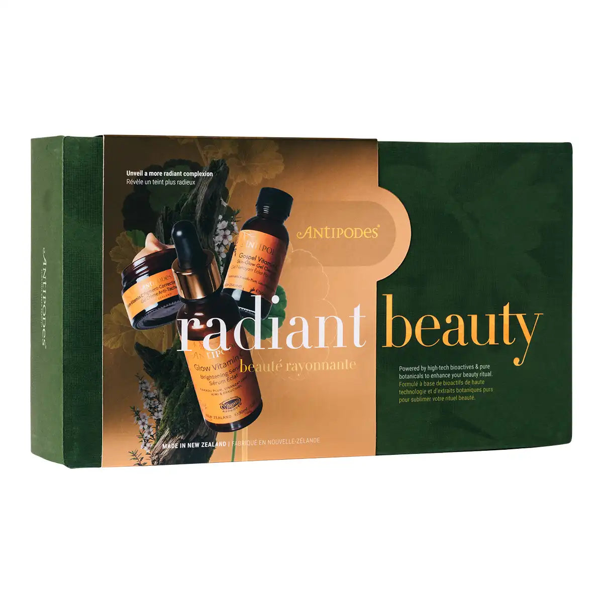 Antipodes Radiant Beauty gift set box, featuring a dark green and gold design with illustrations of botanical elements and three skincare bottles shown on the front.