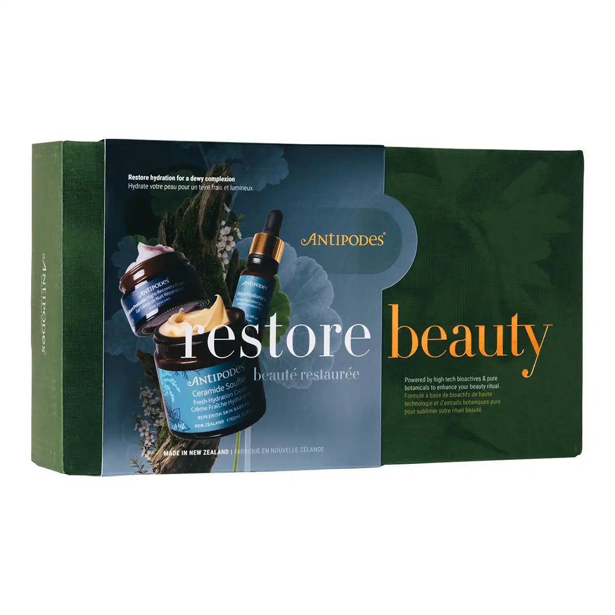 Antipodes Restore Beauty skincare set in a rectangular box, featuring a dark green and blue design with product imagery of a jar, cream, and dropper bottle.