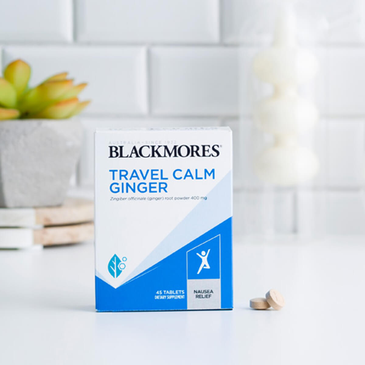 Blackmores Travel Calm Ginger box packaging next to tablets on a white surface.