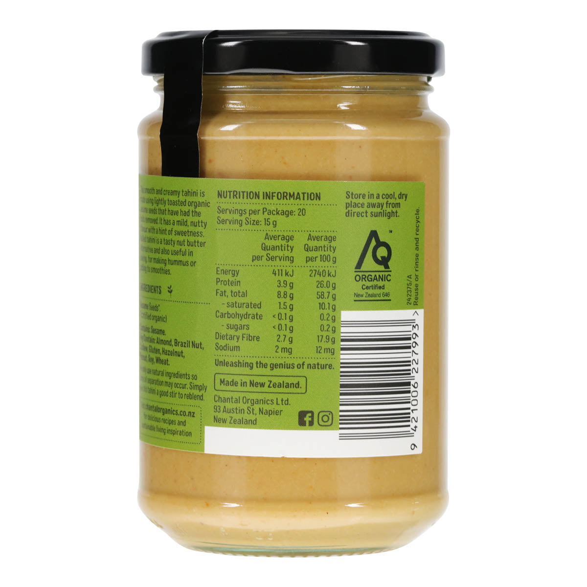 Jar of hulled tahini with a green label showing nutrition information on a white background