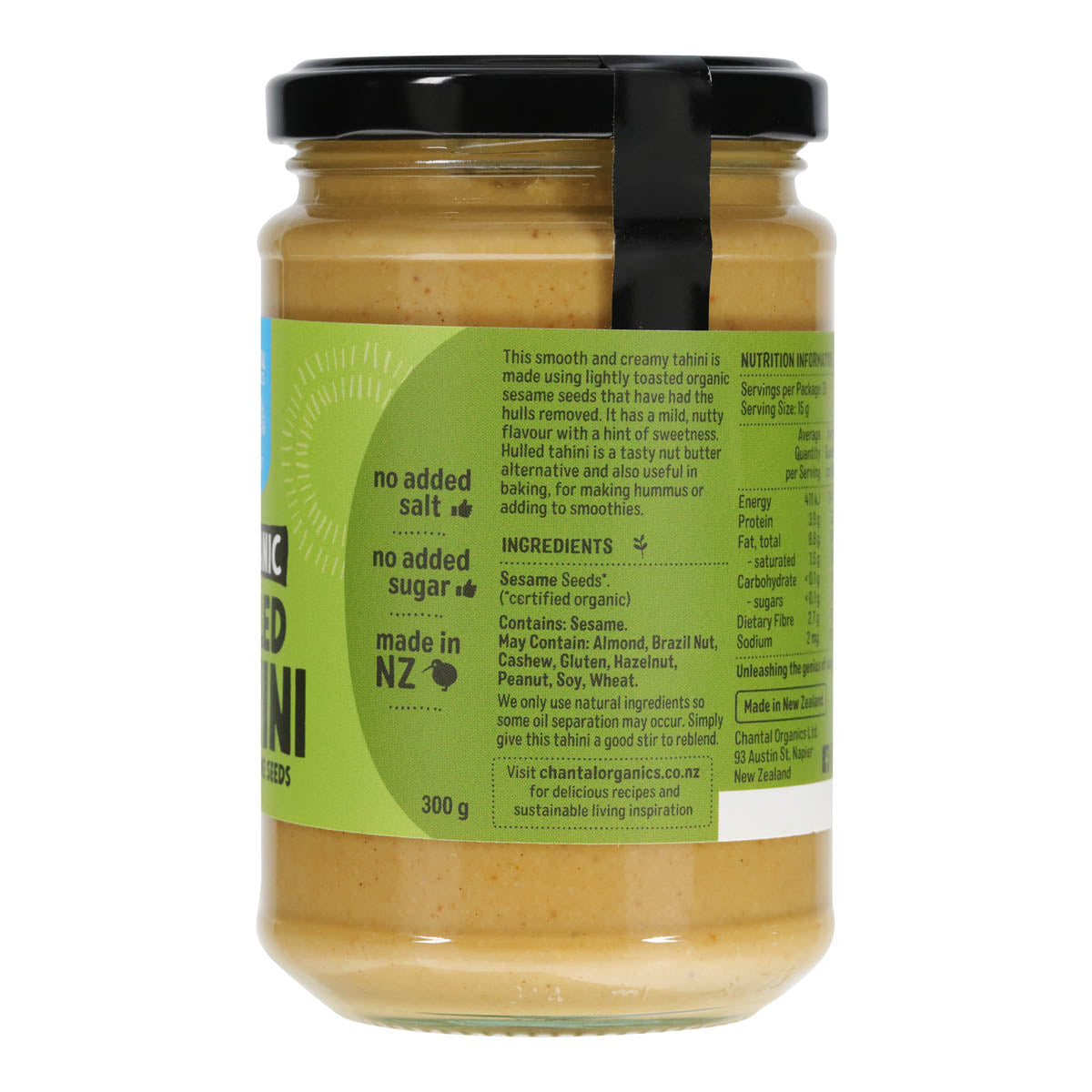 Jar of Chantai Organics tahini showing side of green label with ingredients and product information on a white background