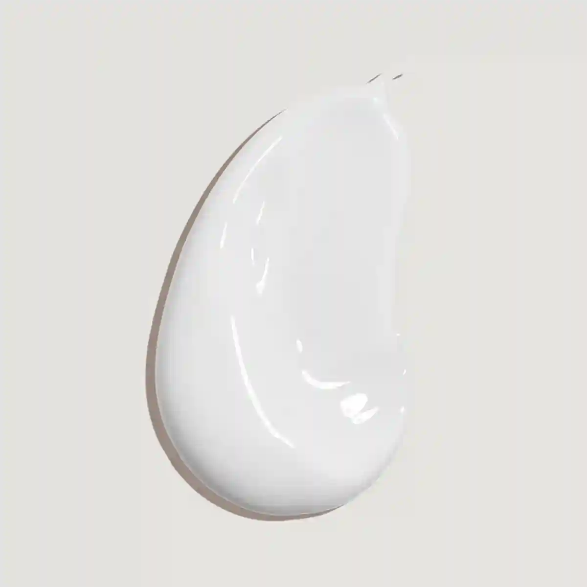 White ceramic teardrop-shaped plate on a light gray background
