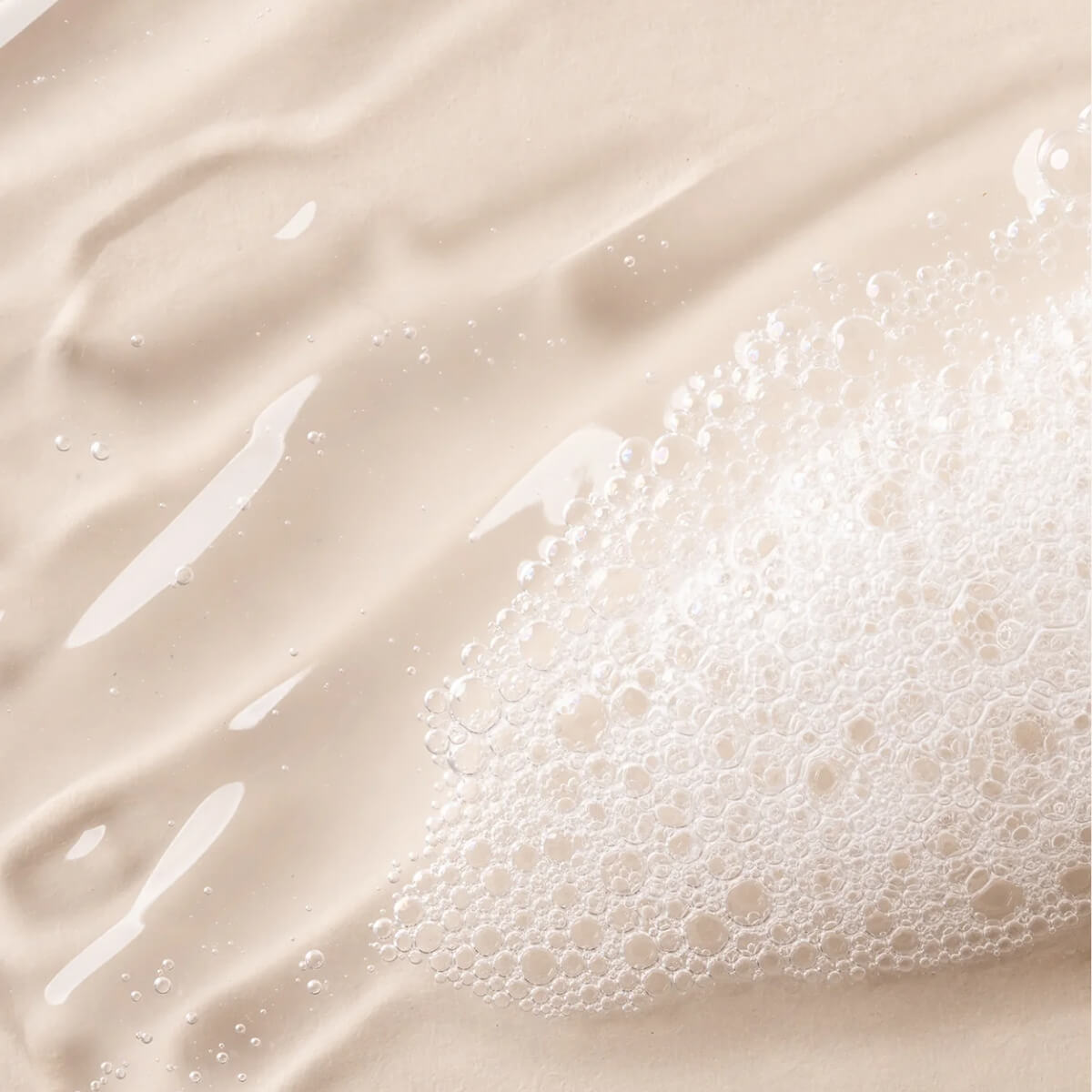 Close-up of a beige liquid with bubbles.