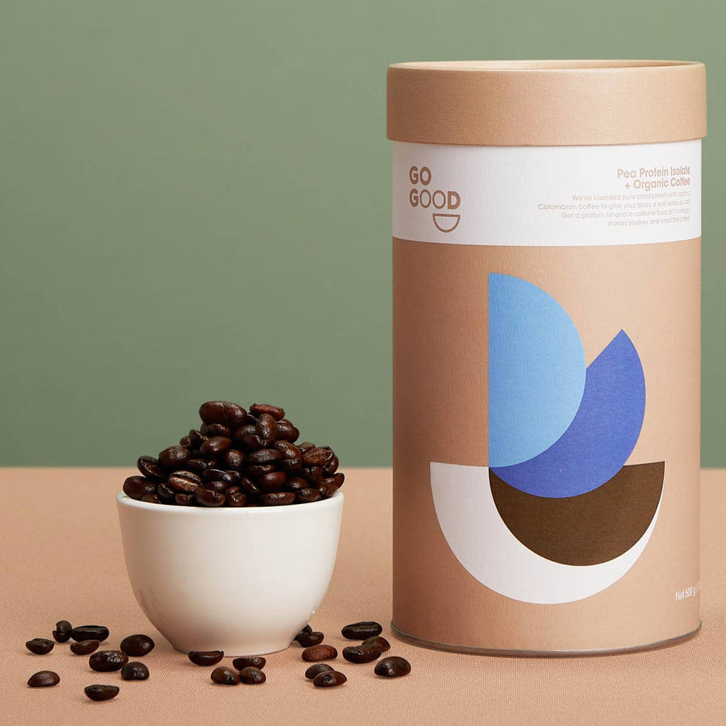 Go Good coffee packaging with a bowl of coffee beans on a beige surface.