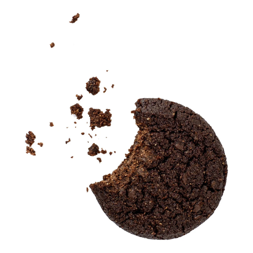Chocolate cookie with a bite taken out of it on a white background