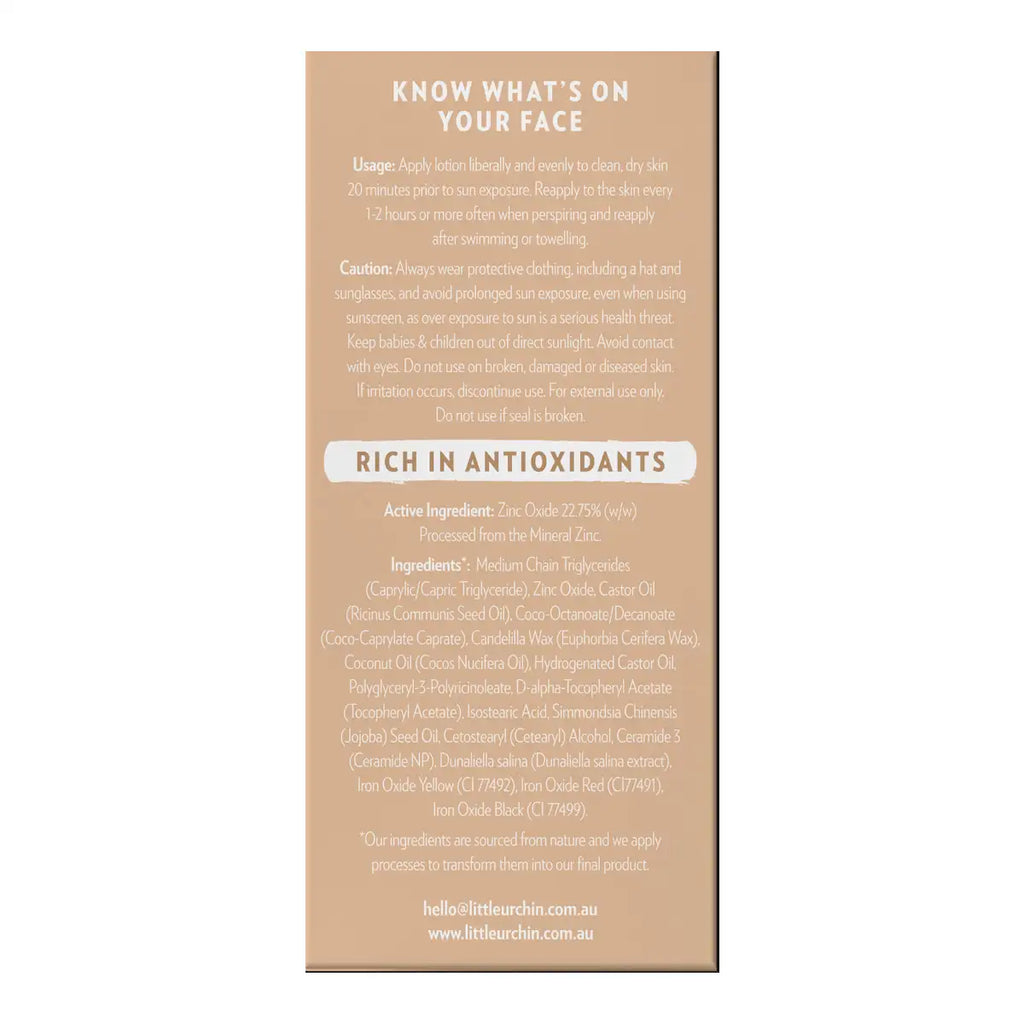 A beige product box with black text detailing the usage, caution, and ingredients of tinted sunscreen.