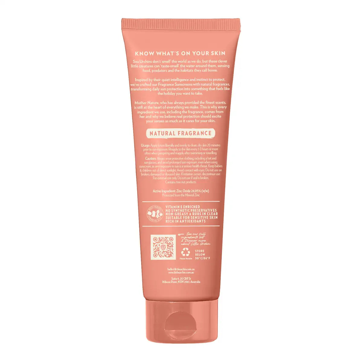 The back of a coral pink squeeze tube for sunscreen, showing detailed ingredient and usage text, on a solid white background.