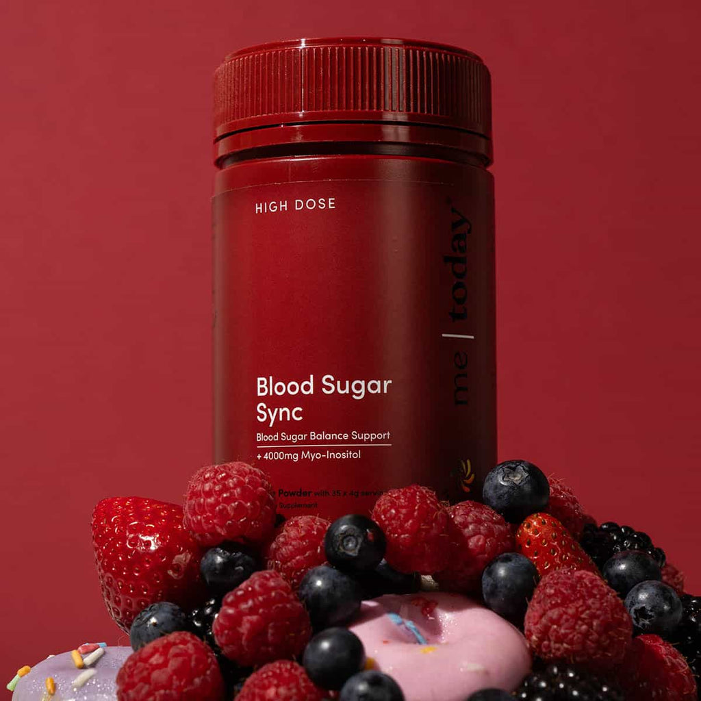 Red supplement bottle labeled 'Blood Sugar Sync' with berries on a red background