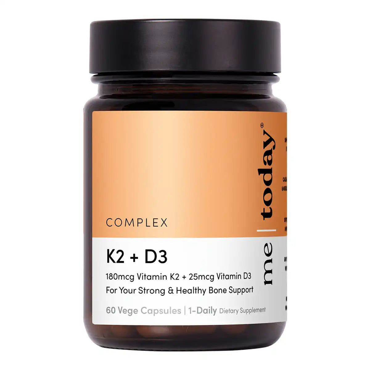 A dark amber glass bottle of K2 + D3 dietary supplement with a black cap and an orange and white label.