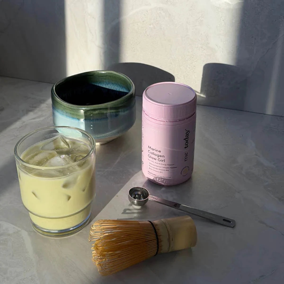 Me Today Marine Collagen Glow Girl container next to a green chilled matcha. 