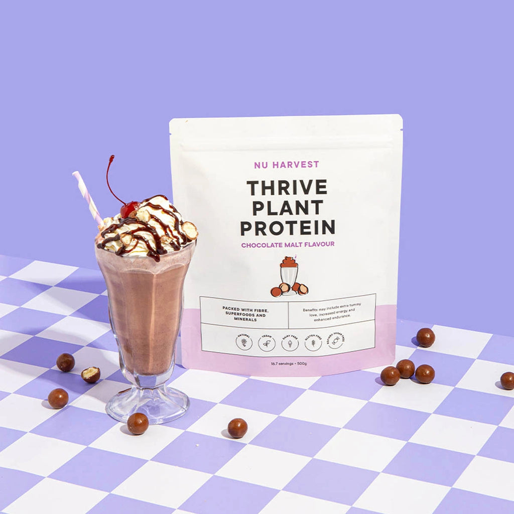 NU HARVEST Thrive Plant Protein package with a chocolate malt protein shake on a checkered tablecloth.
