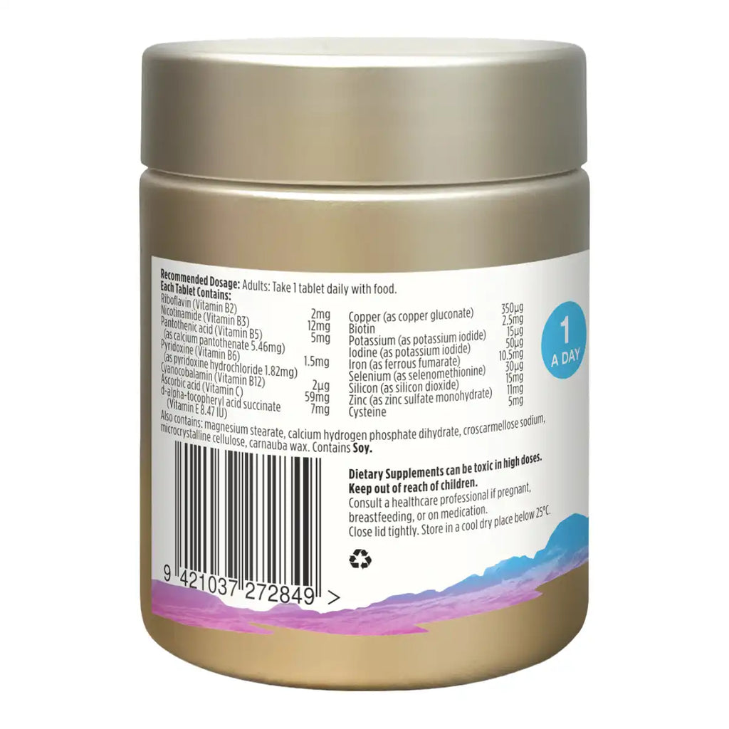 Back side of a gold supplement jar showing printed nutrition facts, barcode, and usage text on a white label.