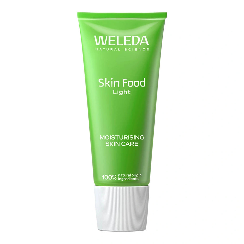 Weleda Skin Food Light in a green tube on a white background.